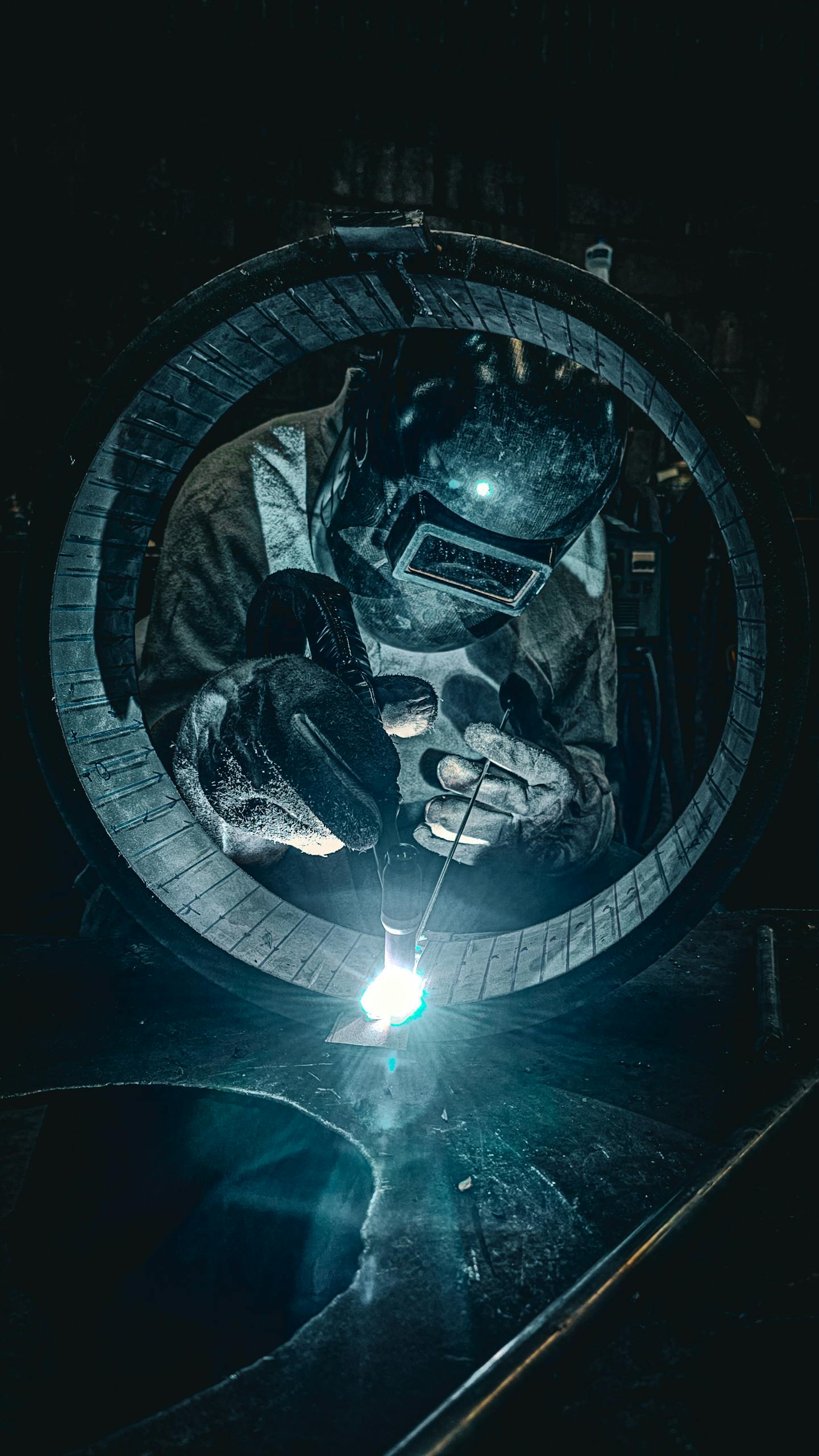 Professional welder at work in a Brazilian factory, showcasing intense precision and focus.